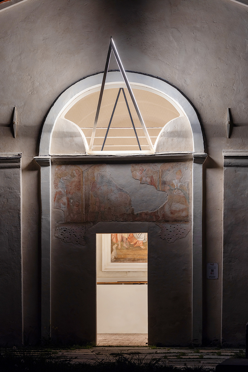 emilio ferro pierces chapel of san rocco with suspended beam of light in italy