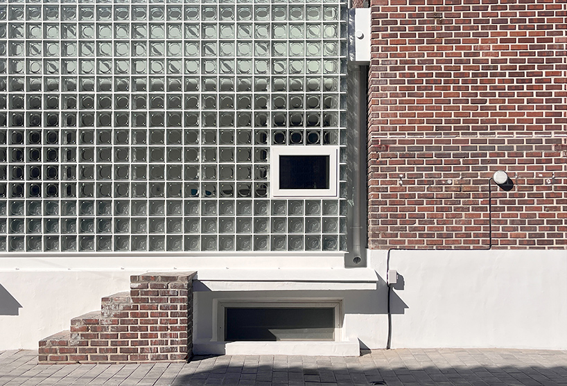 glass block surfaces by studio heech enclose brick structure in seoul