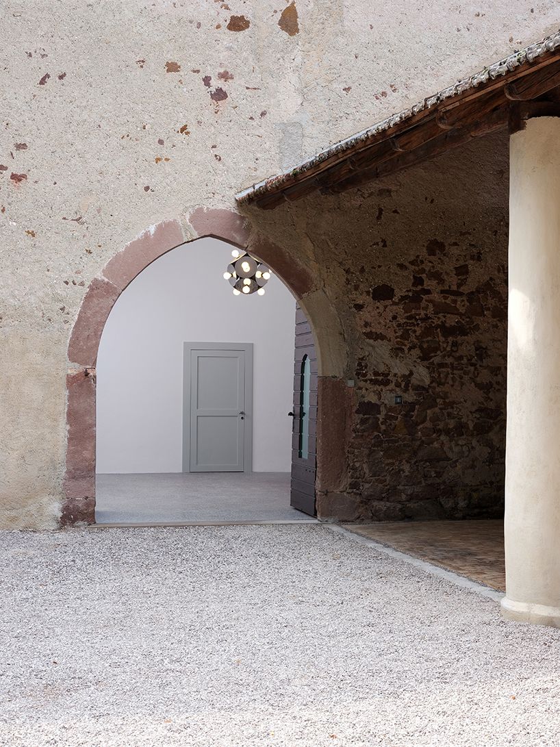 bold colors + geometric shapes revive art library in ganda castle's medieval structure