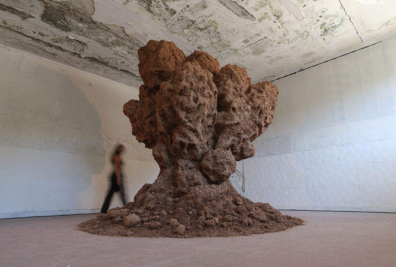 bomb cloud sculpture takes shape in soil, straw and water inside abandoned lisbon school - 1