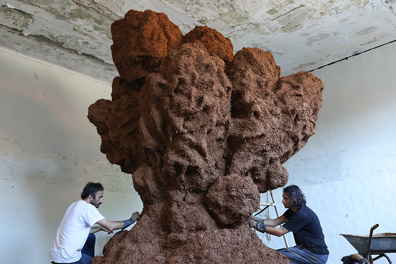 bomb cloud sculpture takes shape in soil, straw and water inside abandoned lisbon school - 2