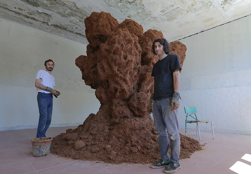 bomb cloud sculpture takes shape in soil, straw and water inside abandoned lisbon school - 5