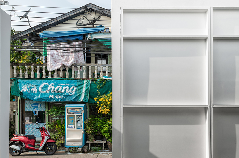 white dense geometric block pops out of urban bangkok neighborhood