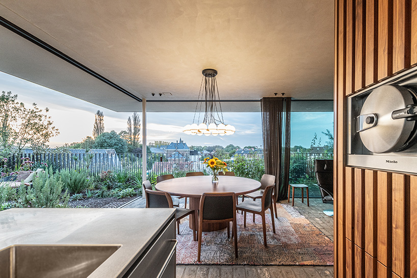 rounded volume made of walnut wood lies in the heart of penthouse T by objekt architecten