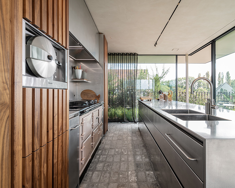 rounded volume made of walnut wood lies in the heart of penthouse T by objekt architecten