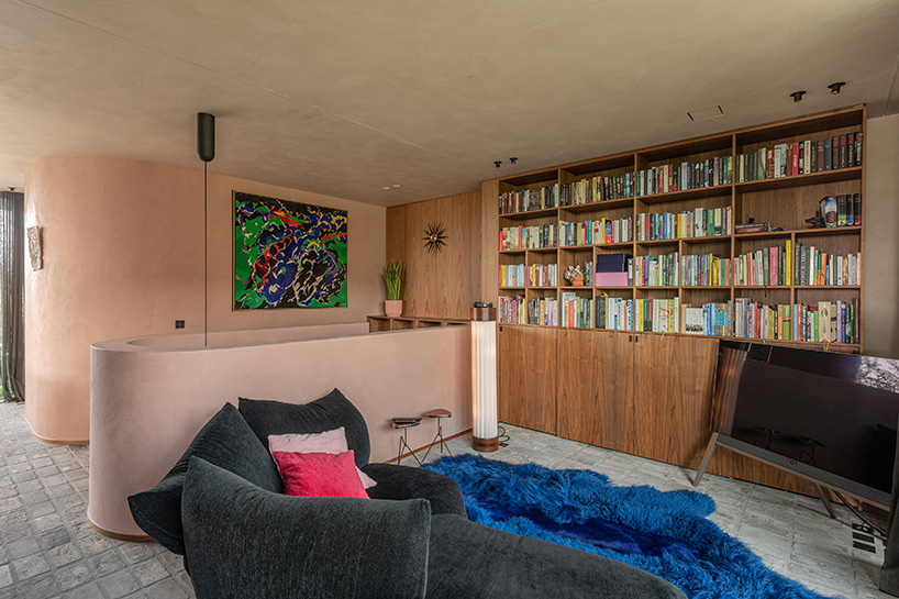 rounded volume made of walnut wood lies in the heart of penthouse T by objekt architecten