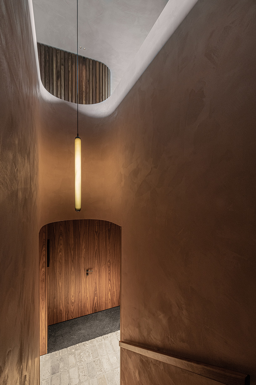 rounded volume made of walnut wood lies in the heart of penthouse T by objekt architecten