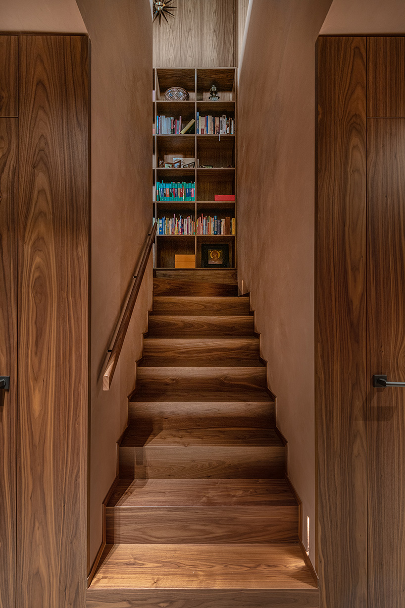 rounded volume made of walnut wood lies in the heart of penthouse T by objekt architecten