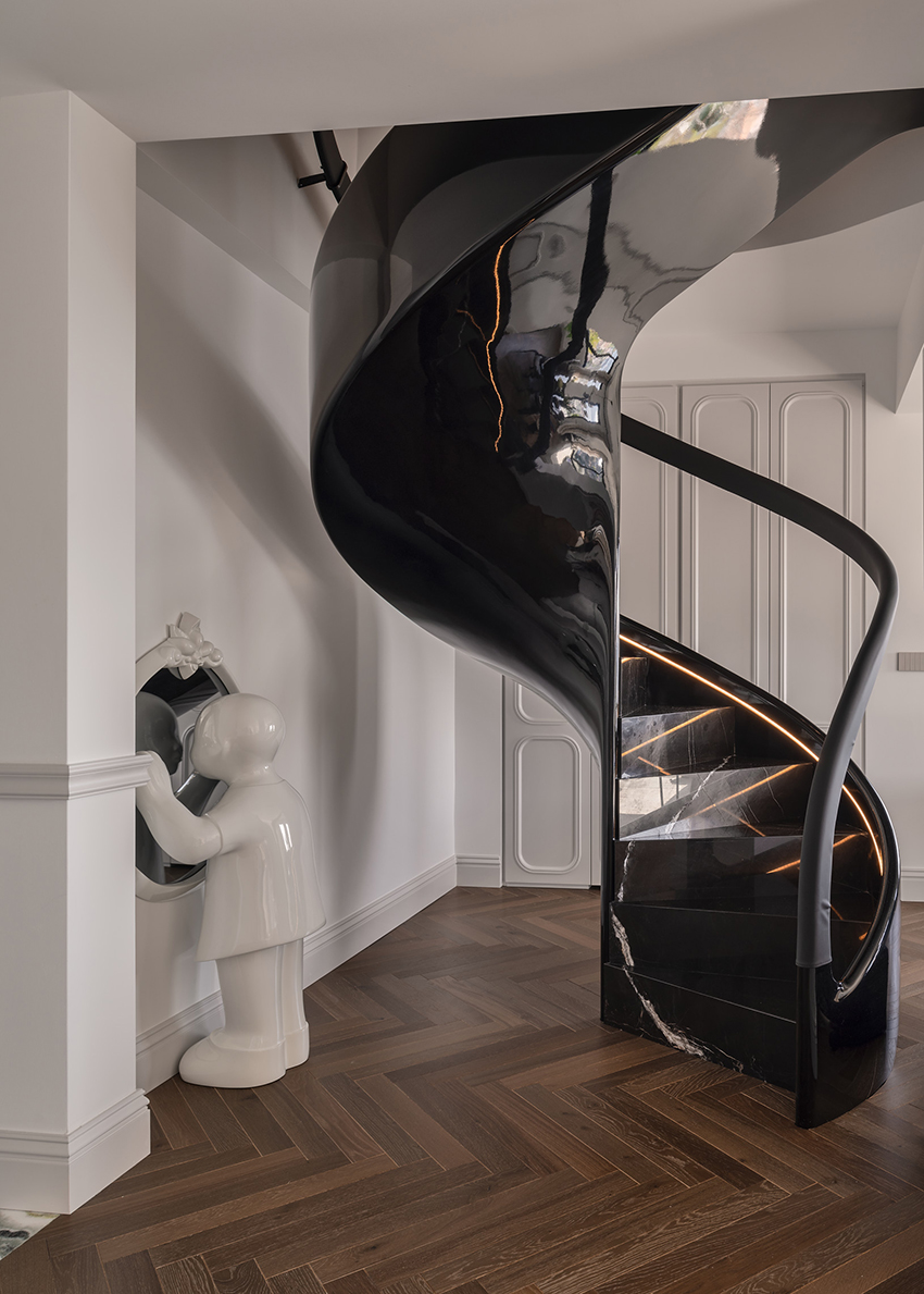 reflective sculptural staircase interposes in renovated roof apartment in istanbul