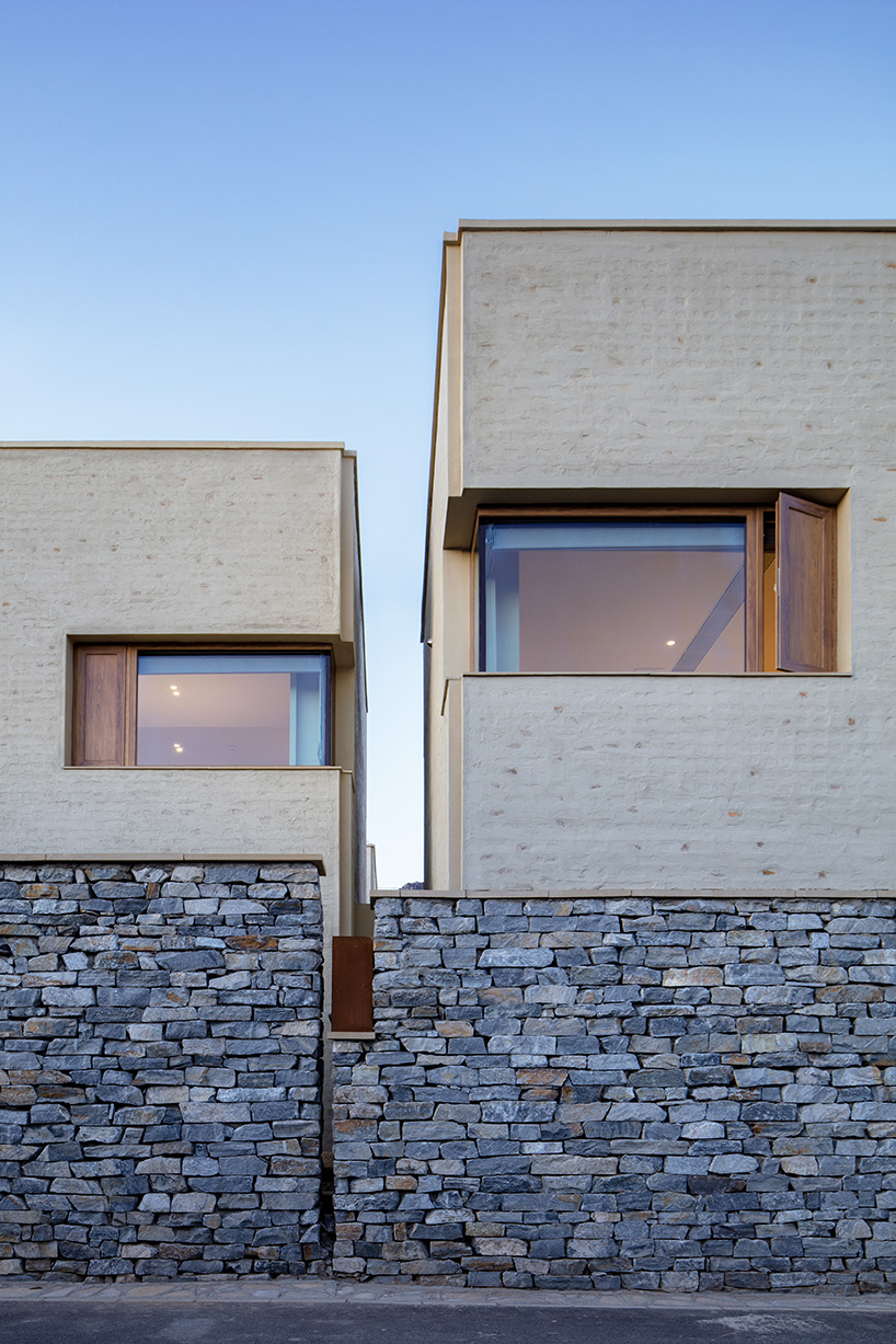 eight interconnected stone-clad buildings compose long circle B&B in beijing