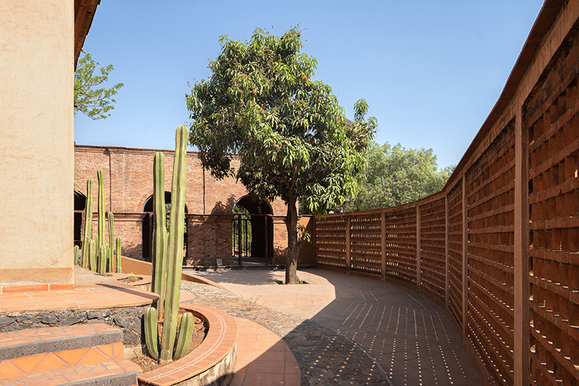 adobe skin made of clay and straw shapes vacation house 'casa corsal' in mexico