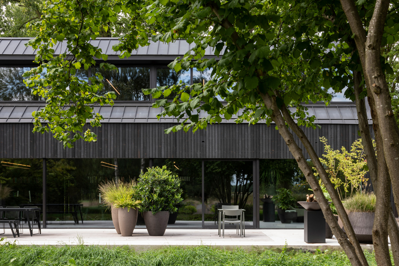 studio] [space nestles black barn-shaped office into the dutch landscape