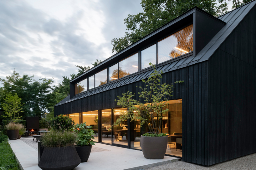 studio] [place nestles black barn-shaped place of work into the dutch landscape