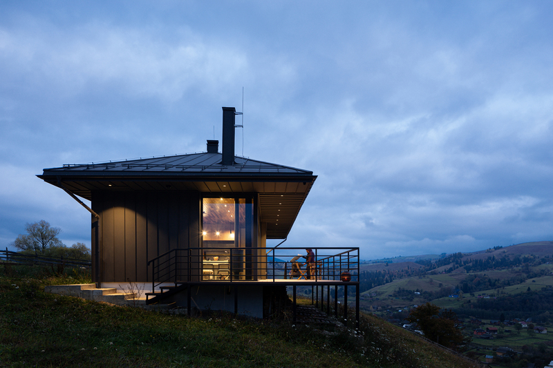 traditional wood-sewn roof tops cottage in ukraine overlooking the carpathian mountains