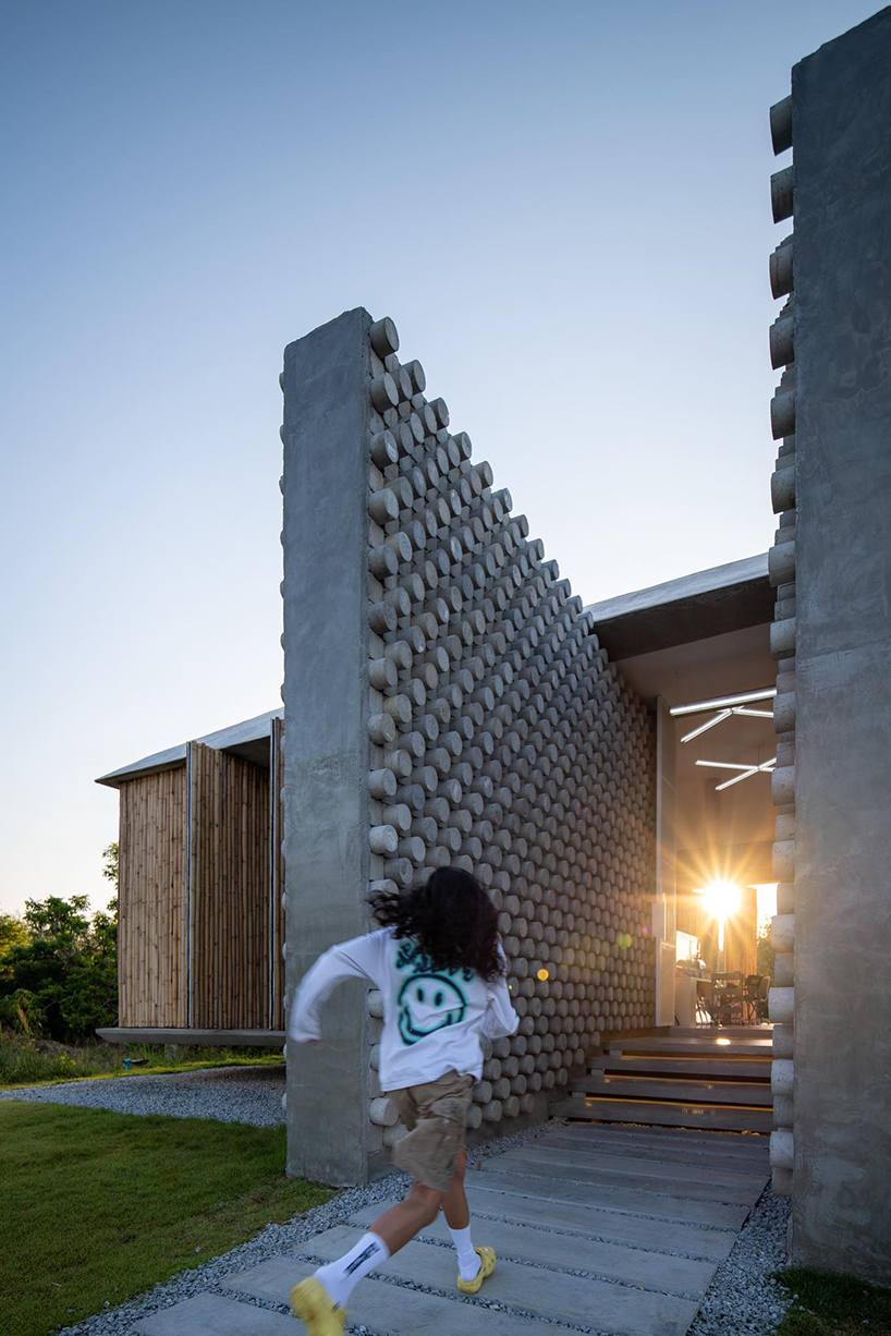 bamboo battens and discarded concrete spacers envelope art studio by 11.29 studio in thailand