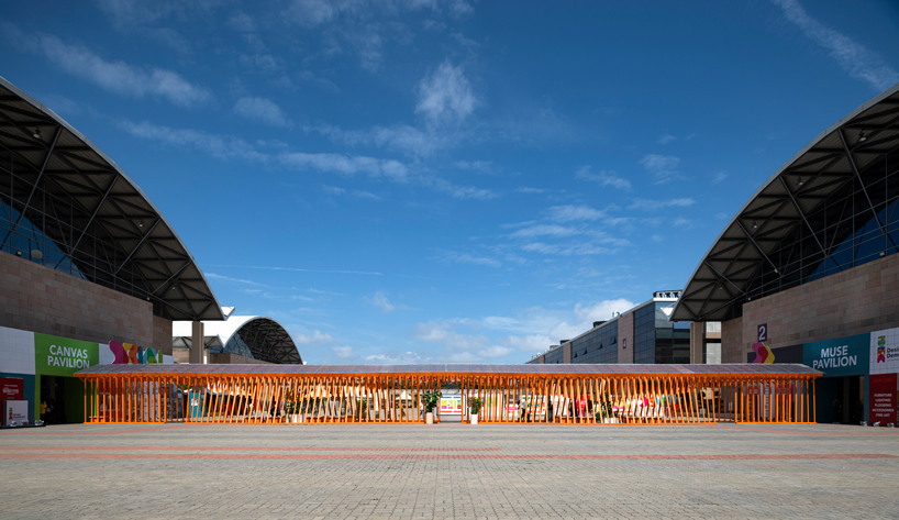 Un pabellón desnudo móvil forma un sinuoso puente de acero entre dos salas de exposiciones en la India