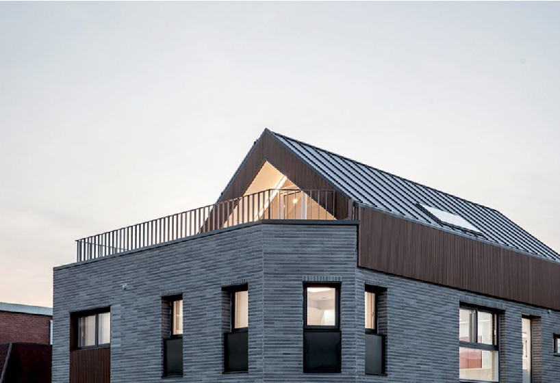 brick tiled residential building stands out in an alley of seoul
