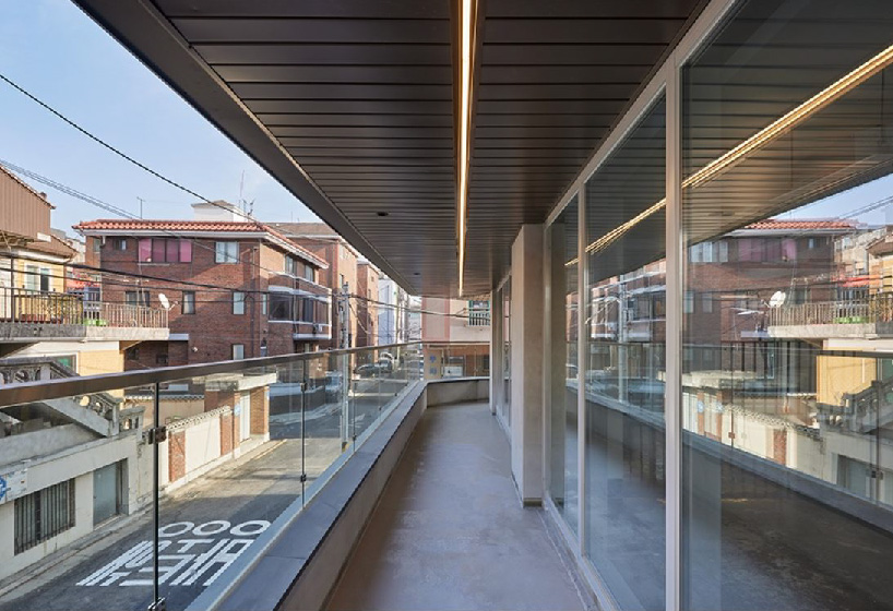 brick tiled residential building stands out in an alley of seoul