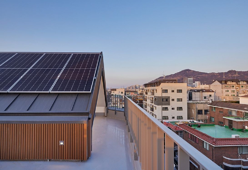 brick tiled residential building stands out in an alley of seoul
