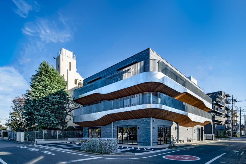 wavy wooden terraces overhang organically in residential neighborhood of japan