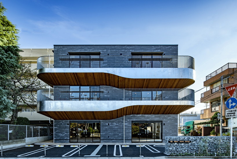 wavy wooden terraces overhang organically in residential neighborhood of japan