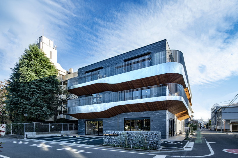 wavy wooden terraces overhang organically in residential neighborhood of japan
