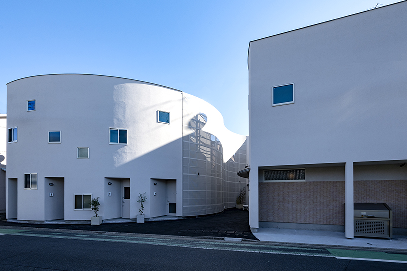 curved residential development shapes a vibrant 'pocket' in japanese cityscape