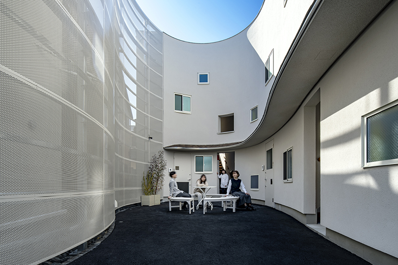 curved residential development shapes a vibrant 'pocket' in japanese cityscape