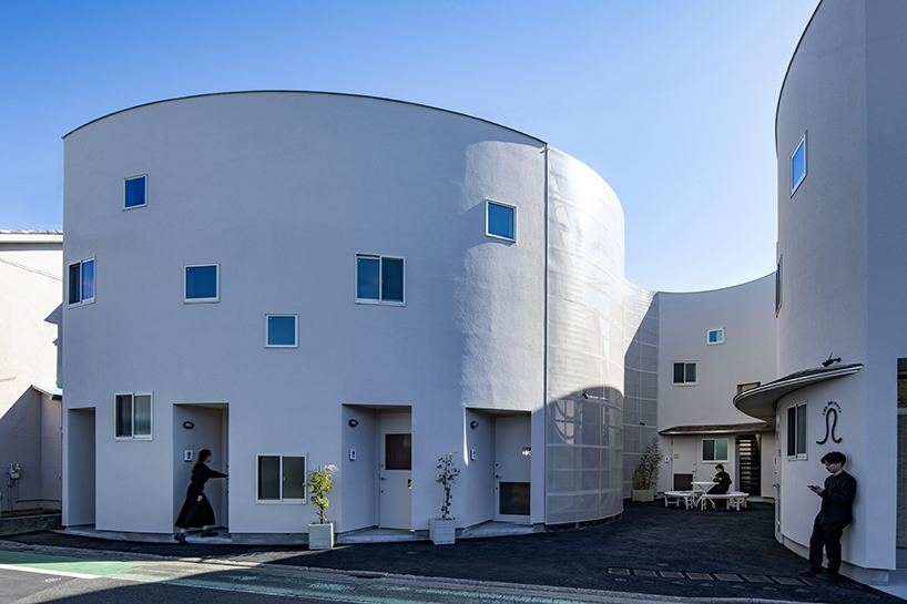 curved residential development shapes a vibrant 'pocket' in japanese cityscape