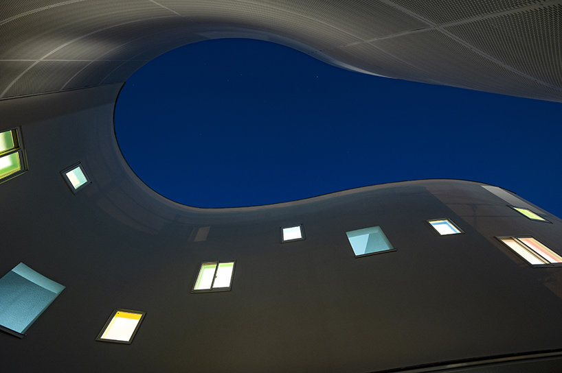 curved residential development shapes a vibrant 'pocket' in japanese cityscape