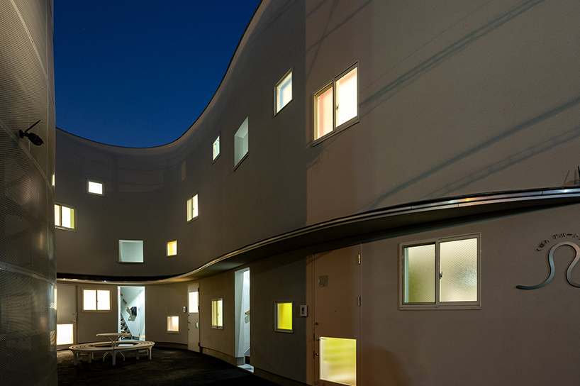 curved residential development shapes a vibrant 'pocket' in japanese cityscape