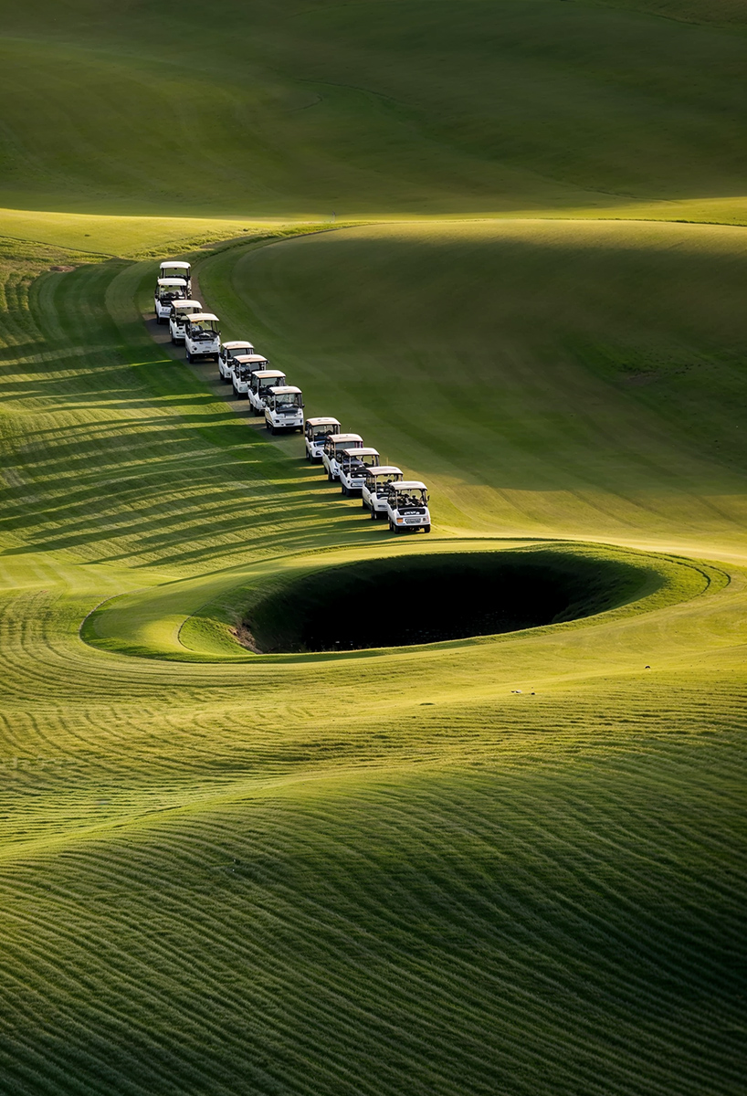 ulises studio's digital images stage hypnotic procession of golf carts tracing invisible lines