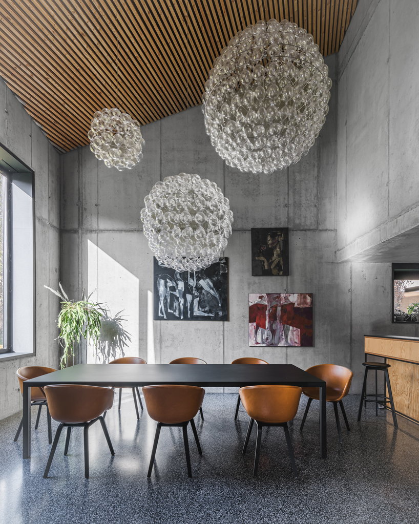 fragmented residence wraps in raw larch slats in polish countryside