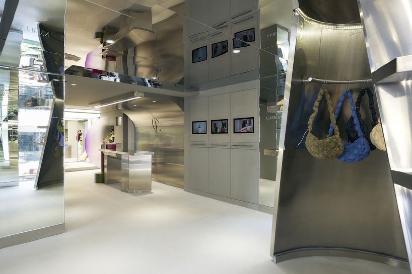 mirroring steel coats carlyn showroom's fluid curved interiors in seoul