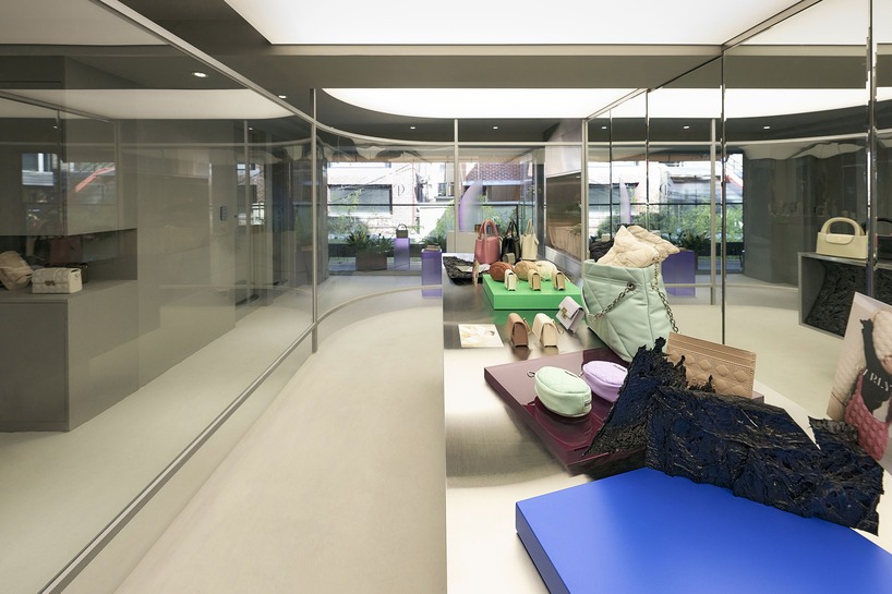 mirroring steel coats carlyn showroom's fluid curved interiors in seoul
