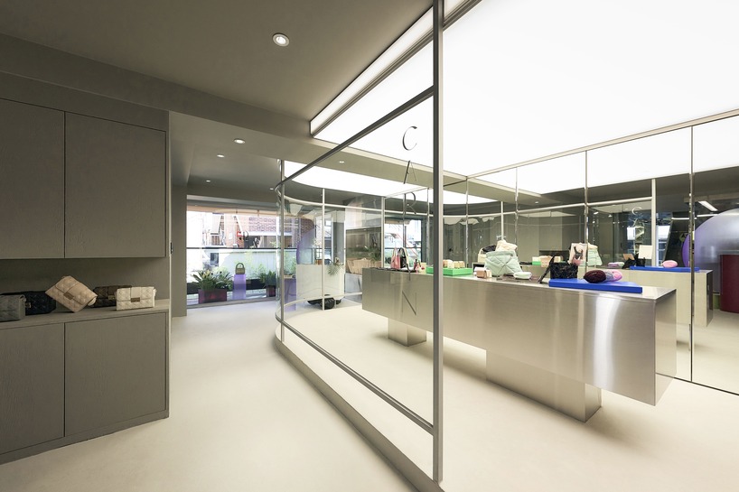 mirroring steel coats carlyn showroom's fluid curved interiors in seoul