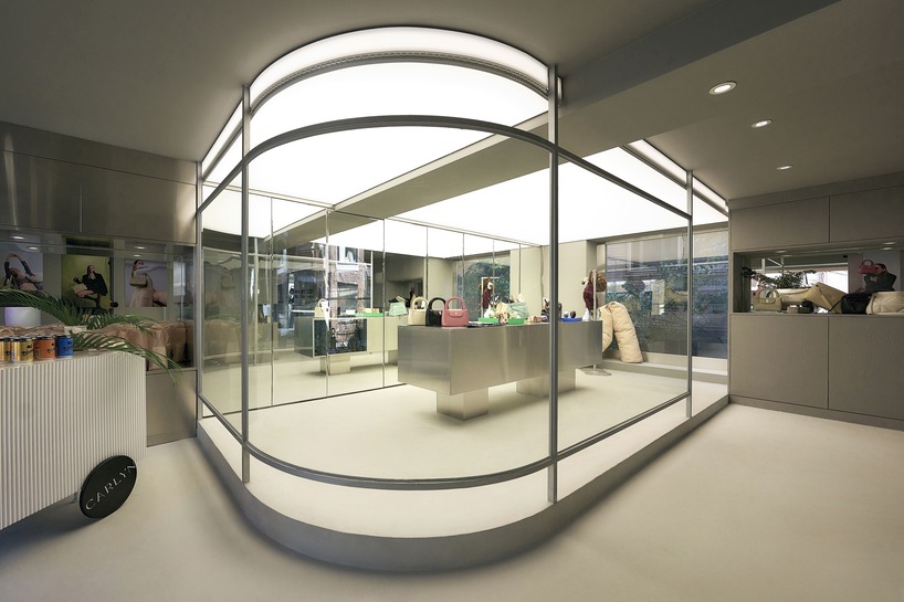 reflective steel coats carlyn showroom's fluid curved interiors in seoul