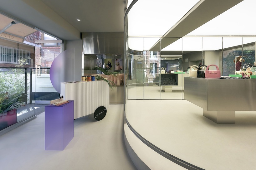mirroring steel coats carlyn showroom's fluid curved interiors in seoul