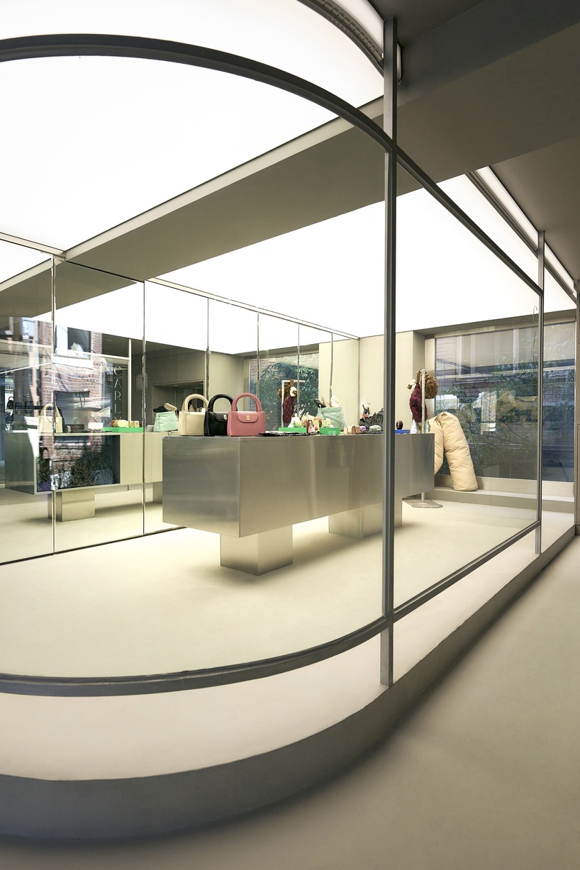 mirroring steel coats carlyn showroom's fluid curved interiors in seoul