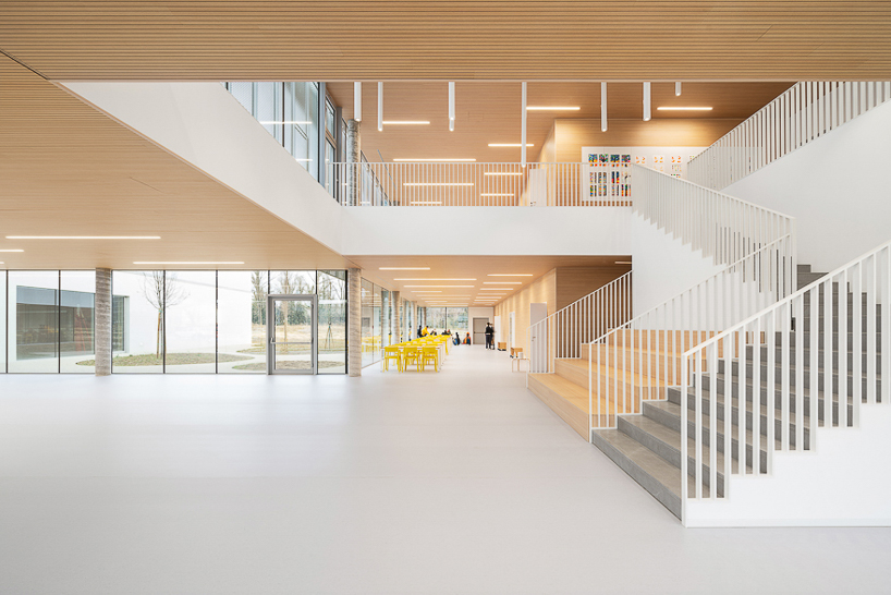 artico fracassi wraps italian school in glass and perforated encasing to bring the outdoors in