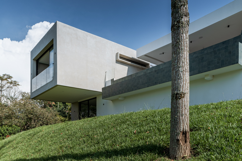 concrete residence expands cantilevered volumes in rural colombia