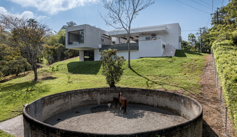 concrete residence expands cantilevered volumes in rural colombia