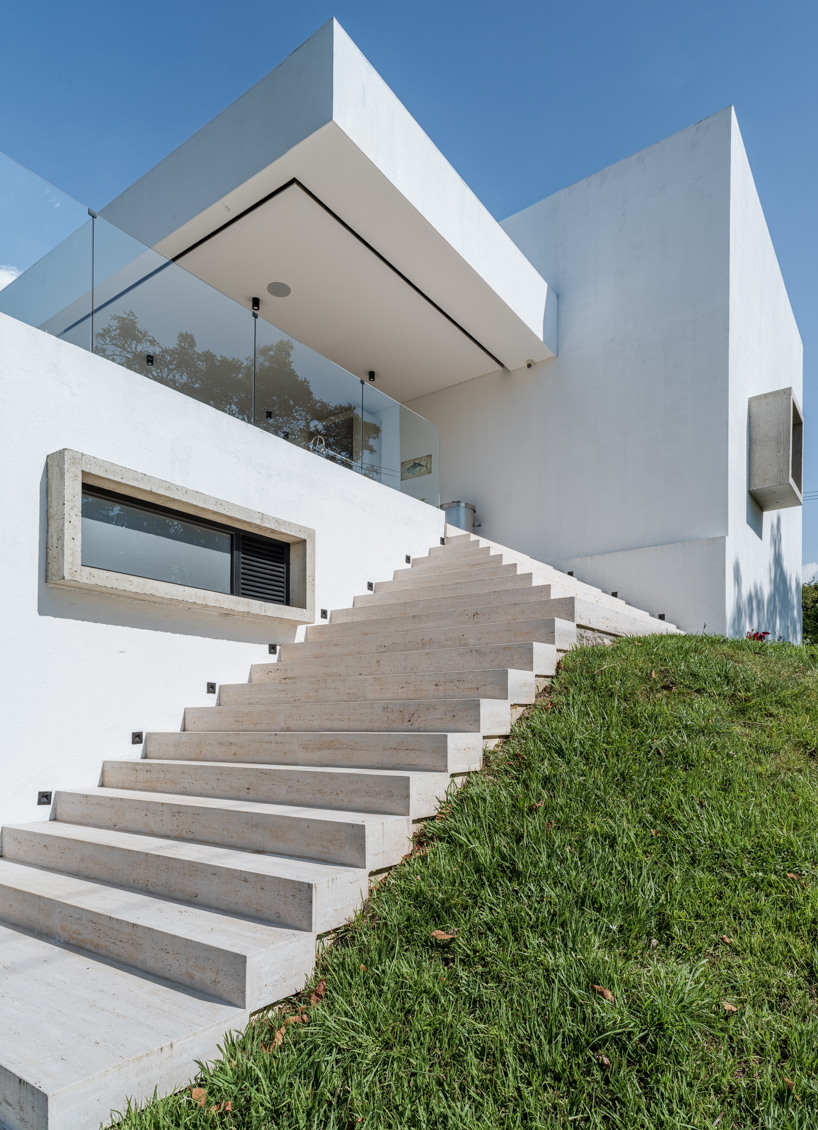 concrete residence expands cantilevered volumes in rural colombia