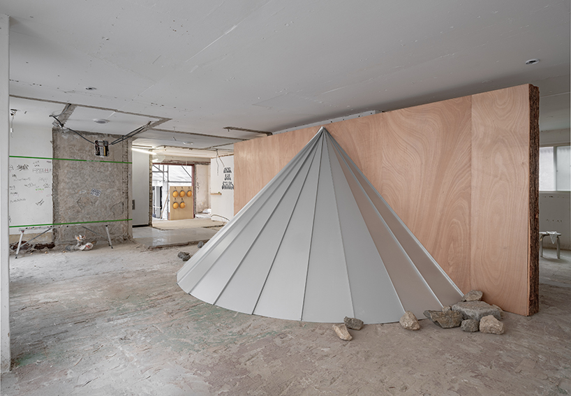 sculptures made of timber and steel occupy raw concrete shell in seoul before demolition - 2