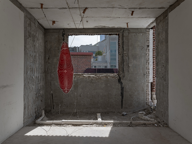 sculptures made of timber and steel occupy raw concrete shell in seoul before demolition - 9