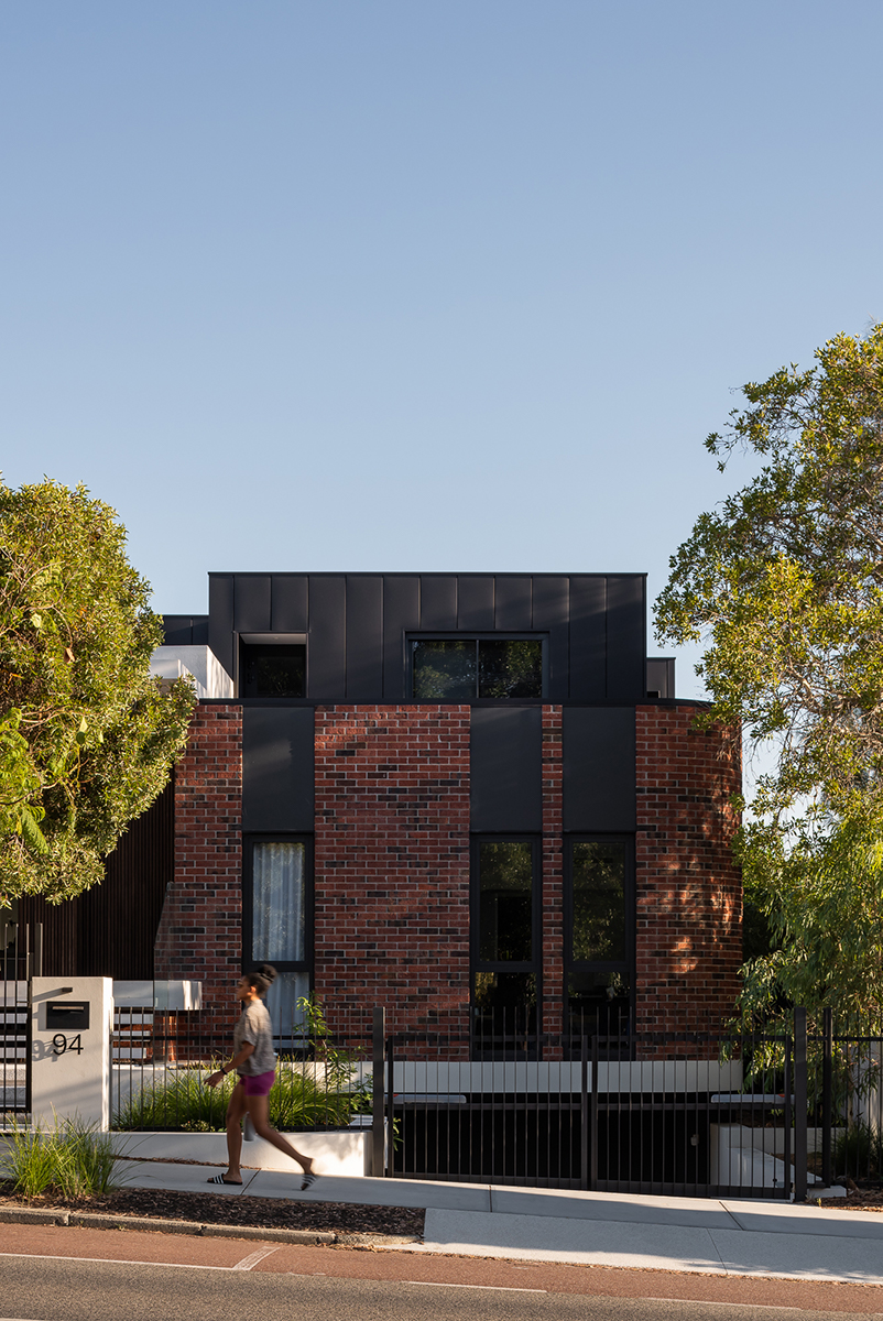 red brickwork and bone-colored walls compose hyde park house's facade in australia