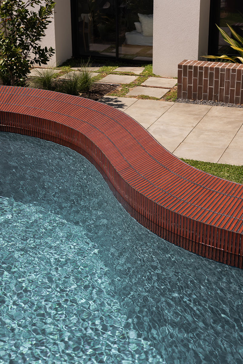 red brickwork and bone-colored walls compose hyde park house's facade in australia