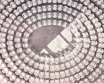 andrea papi's plastic colosseum shaped by stacked chairs brings theater back to the people