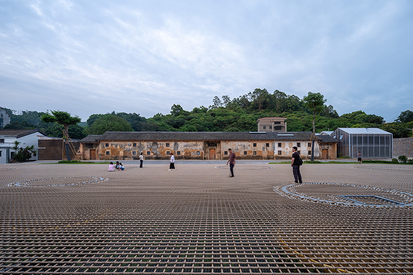 zxd architects stretches large woven net across pond in rural china, inviting rest and play