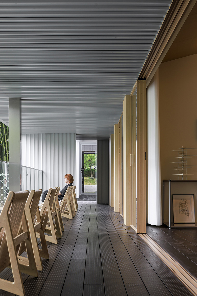 wutopia lab's prefabricated waterfront house in shanghai wraps in aluminum and ceramic skin